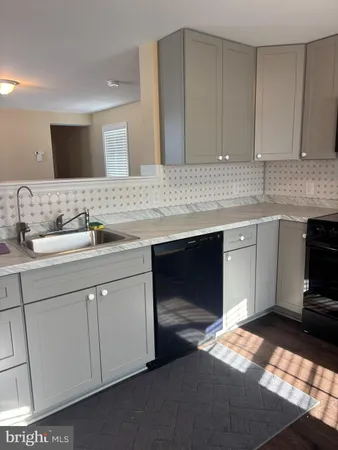 a kitchen with a sink and cabinets