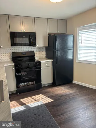 a kitchen with a refrigerator stove and microwave