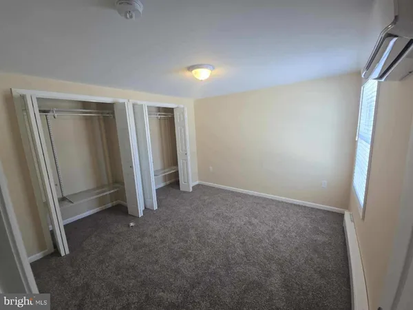 a room with a sink a mirror and cabinets