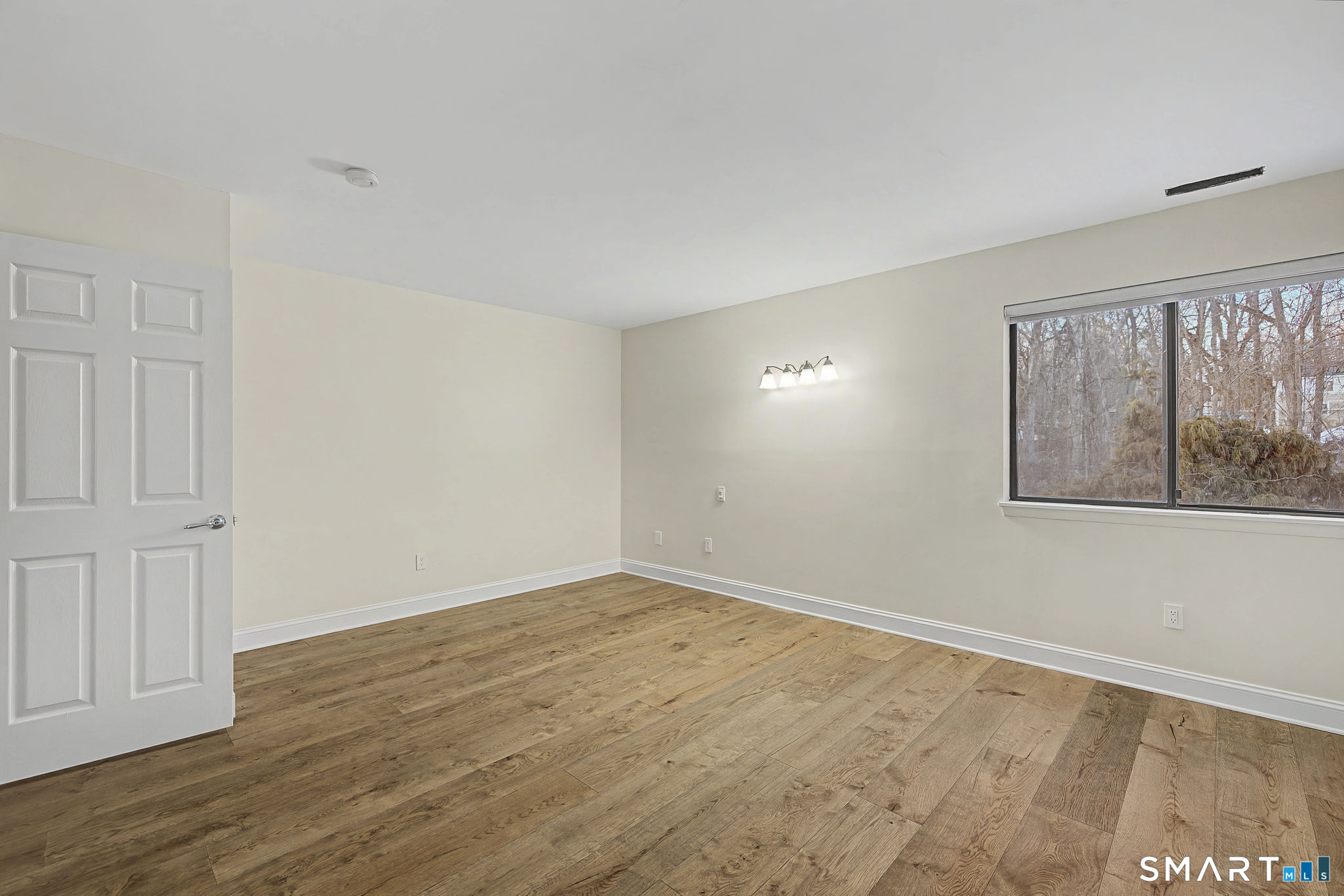123 Old Belden Hill Road, Unit 19 Norwalk, CT 06850 - Photo 23 of 31 a view of an empty room with wooden floor and a window
