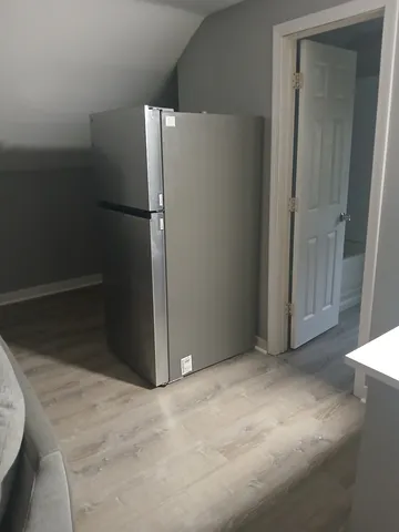 a view of an empty room and wooden floor