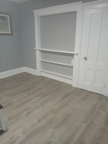 a bedroom with a bed and cabinet
