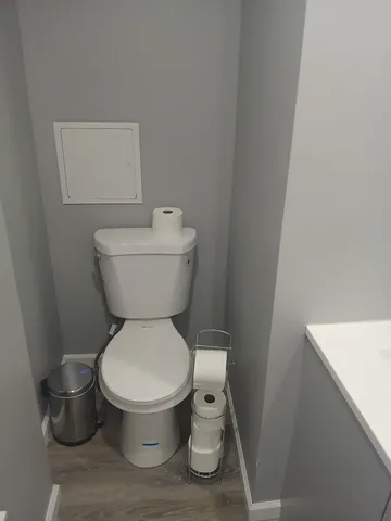 a white toilet sitting next to a white sink