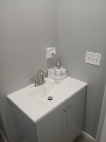 a close up of a sink a vanity and a mirror