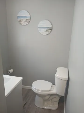a white toilet sitting next to a white sink