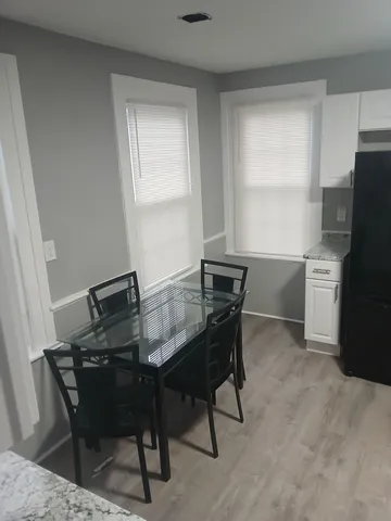 a kitchen with a table chairs and refrigerator