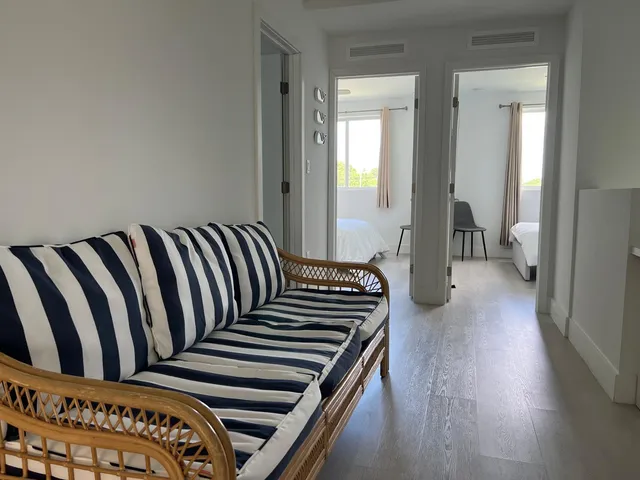 a view of a bedroom with wooden floor