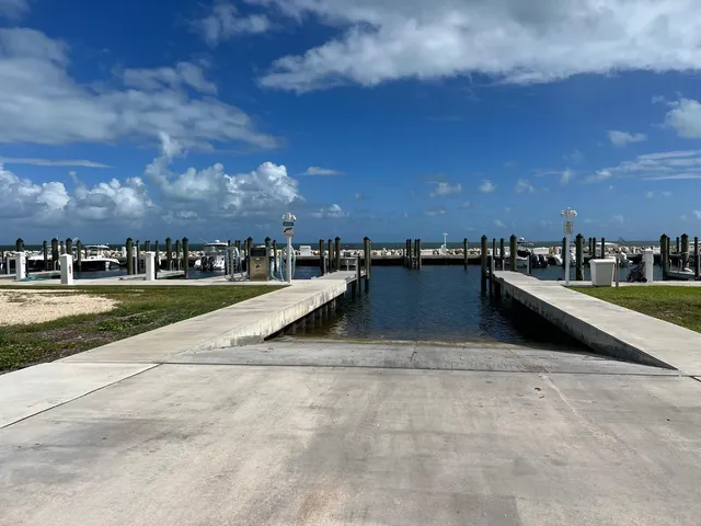 a view of swimming pool with lawn chairs and fire pit