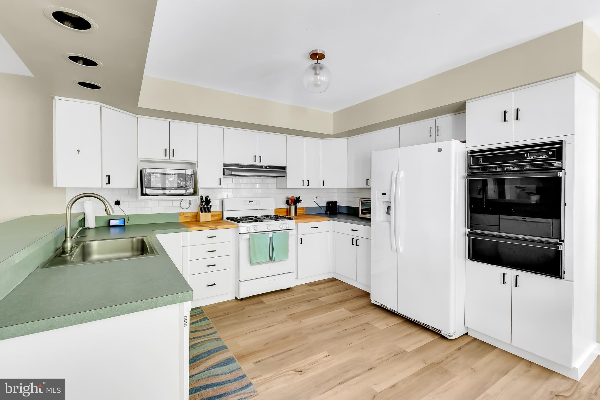 5 Mist Flower Road Ocean Pines, MD 21811 - Photo 16 of 41 a kitchen with stainless steel appliances a refrigerator sink and white cabinets