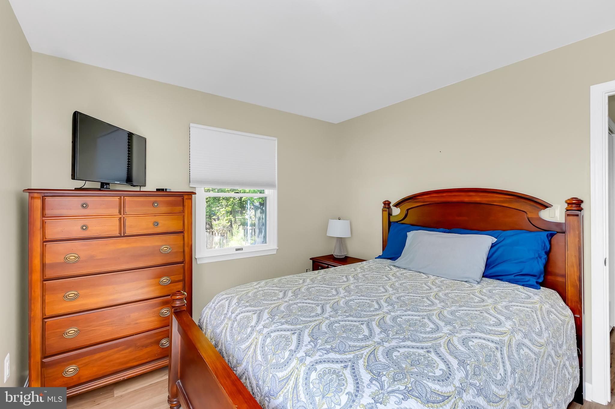 5 Mist Flower Road Ocean Pines, MD 21811 - Photo 27 of 41 a bedroom with a bed and a flat tv screen on dresser