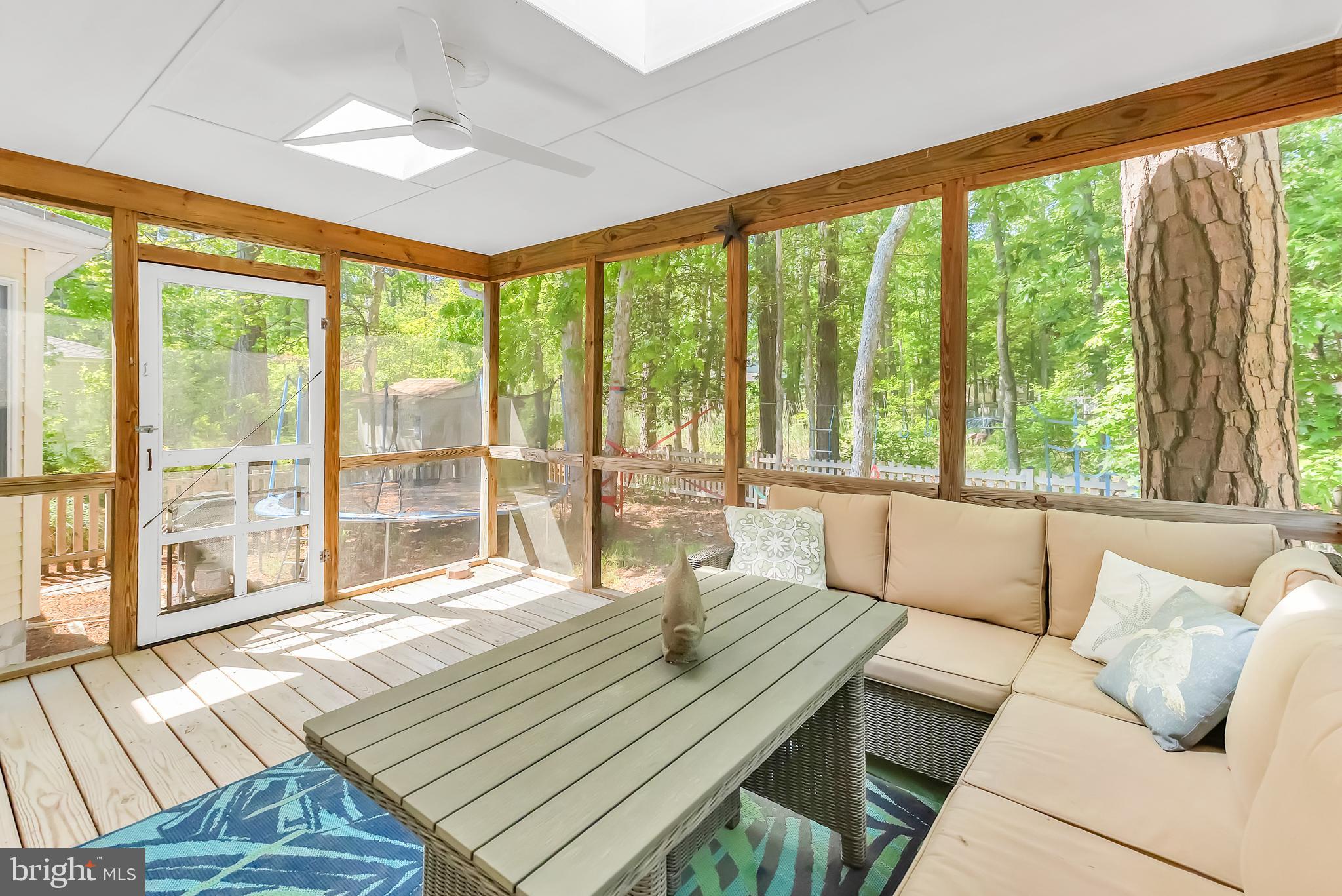 5 Mist Flower Road Ocean Pines, MD 21811 - Photo 32 of 41 a living room with large windows and a table