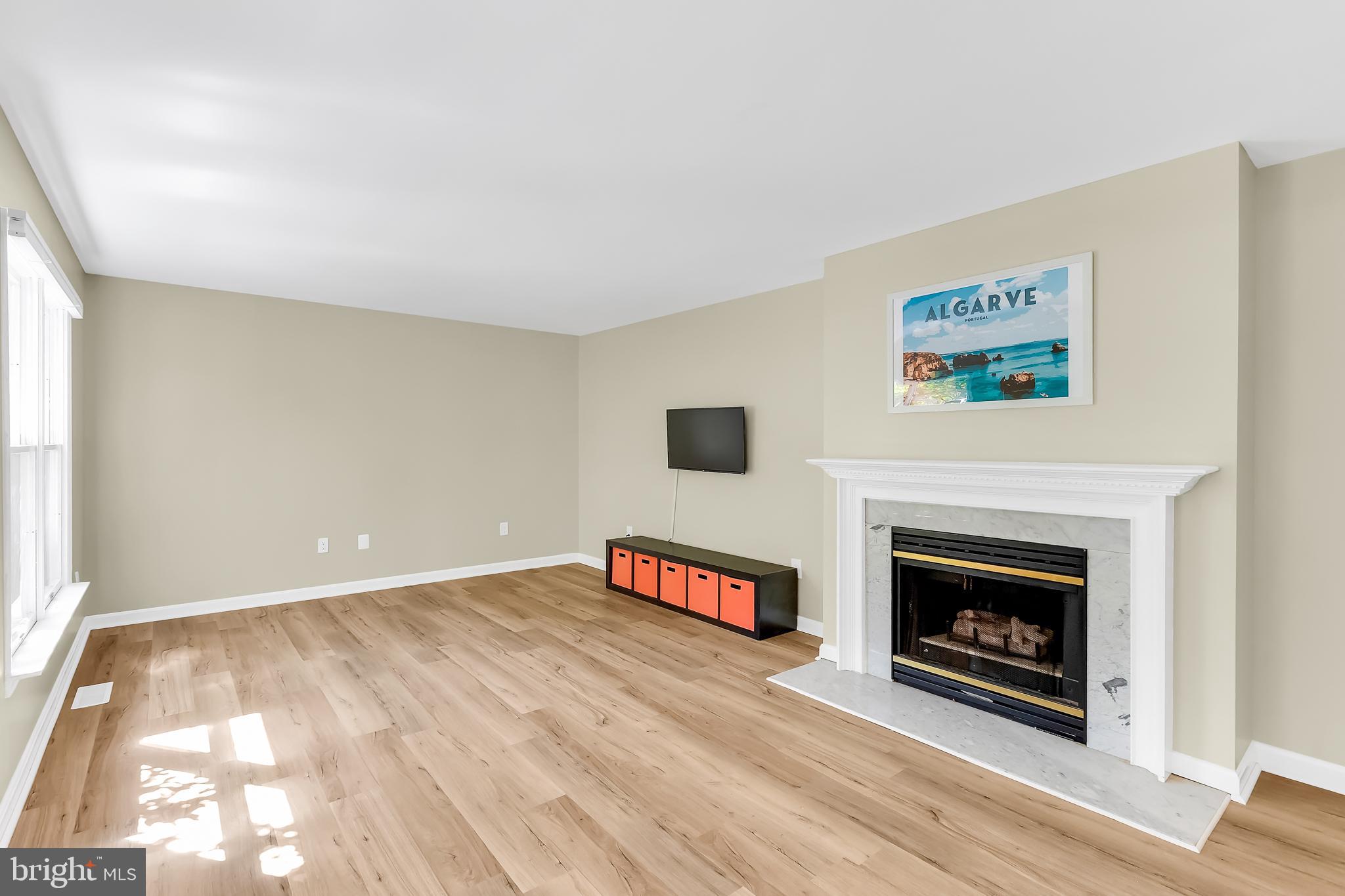 5 Mist Flower Road Ocean Pines, MD 21811 - Photo 8 of 41 a view of an empty room with wooden floor fireplace and a window