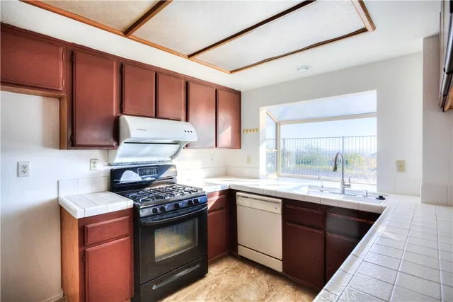 a kitchen with a sink stove and cabinets