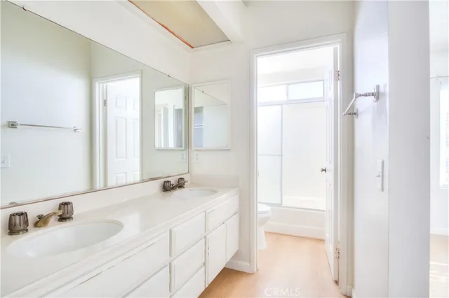 a bathroom with a double vanity sink mirror and