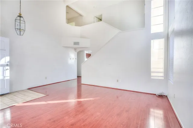 a view of a room with wooden floor and white walls