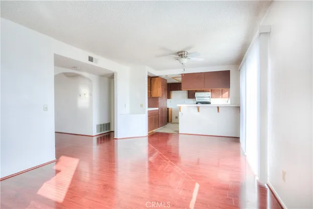 a view of a kitchen with a sink and a refrigerator