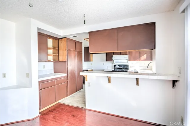 a kitchen with stainless steel appliances a sink stove and cabinets
