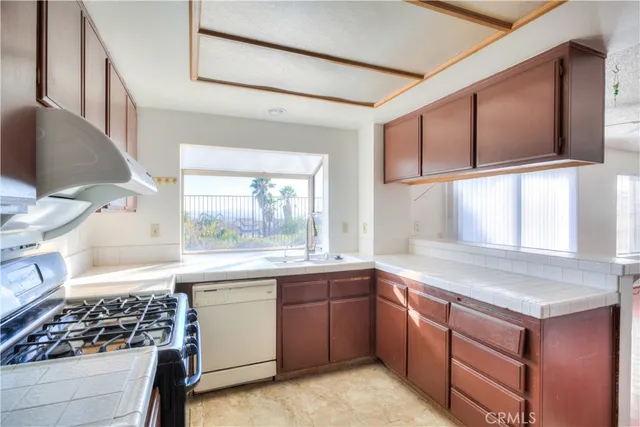 a kitchen that has a sink and a stove