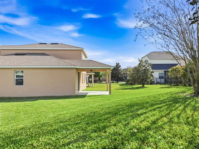 a backyard of a house with table and chairs