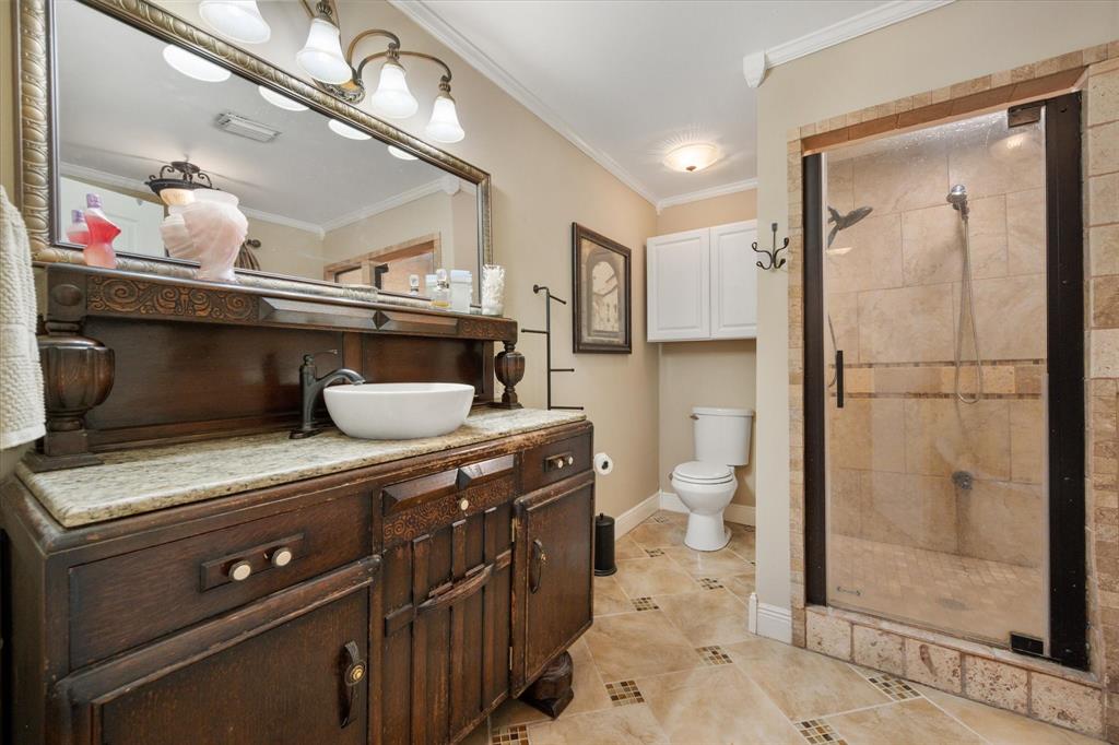 14036 Old Texaco Road Conroe, TX 77302 - Photo 12 of 40 Bathroom featuring a stall shower, visible vents, crown molding, and toilet