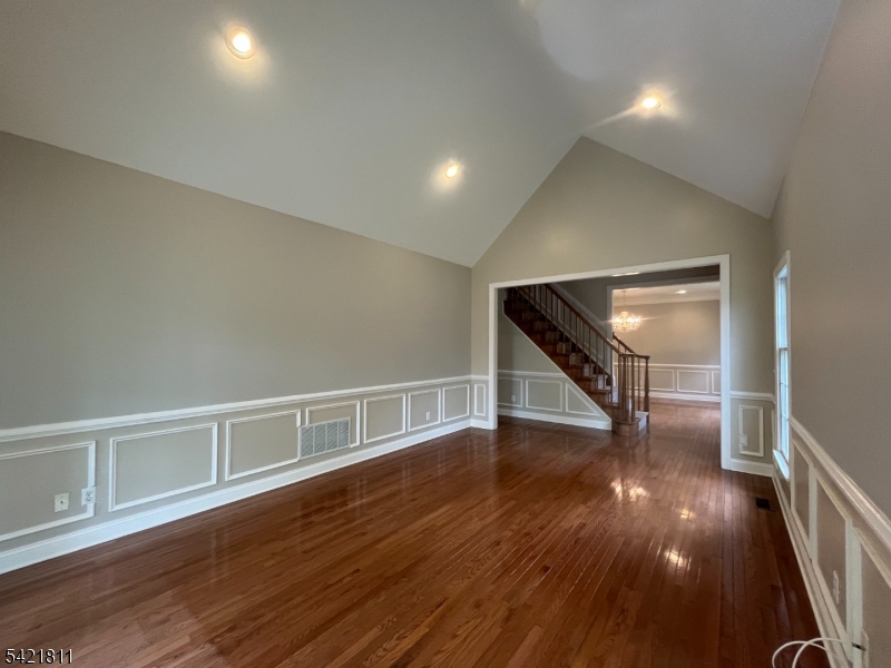 43 Georgetown Court Bernards, NJ 07920 - Photo 12 of 13 a view of an empty room with wooden floor and stairs
