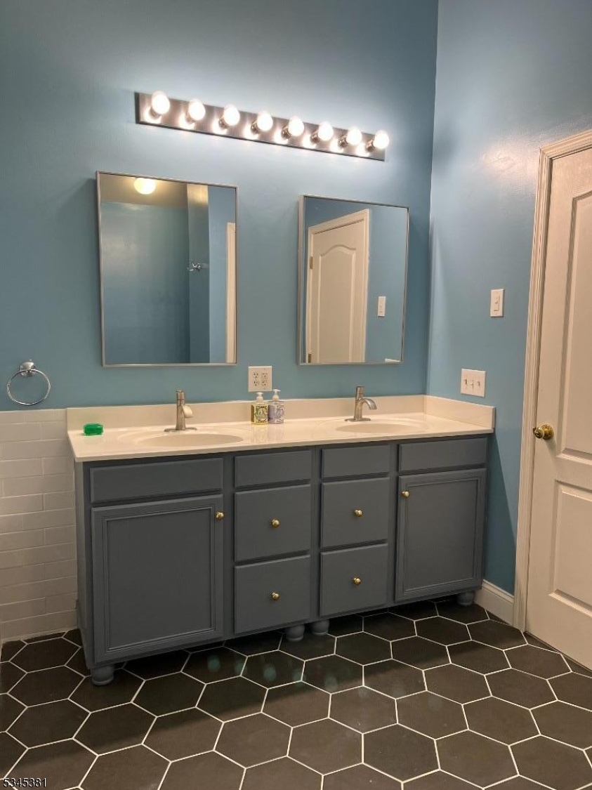 43 Georgetown Court Bernards, NJ 07920 - Photo 8 of 13 a bathroom with a double vanity sink mirror and
