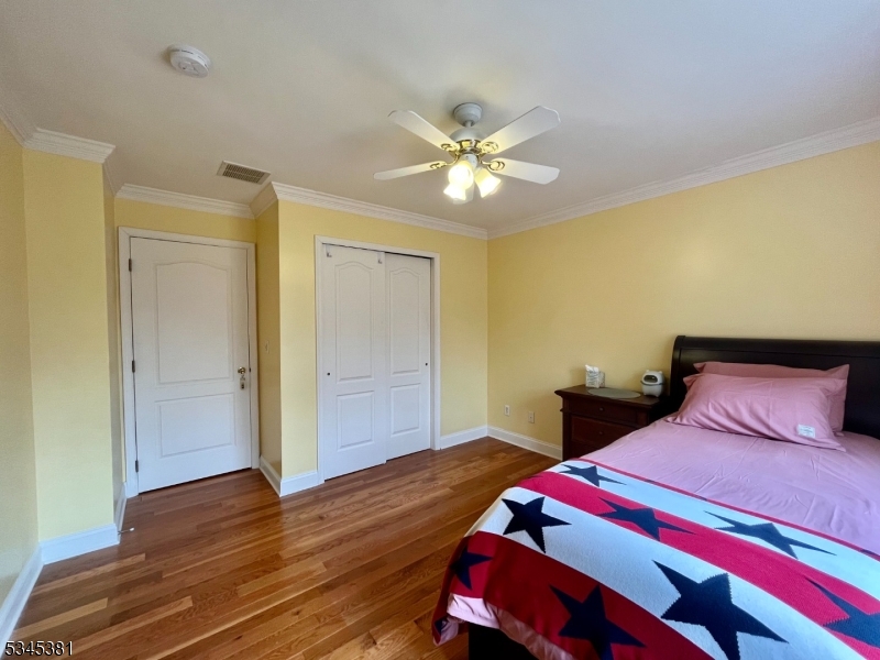 43 Georgetown Court Bernards, NJ 07920 - Photo 10 of 13 a bedroom with a bed and wooden floor