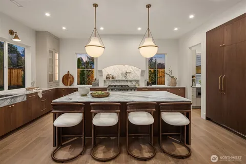 a kitchen with a sink and chairs