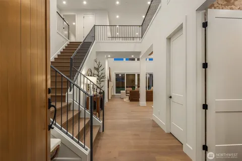 a view of entryway and hall with wooden floor