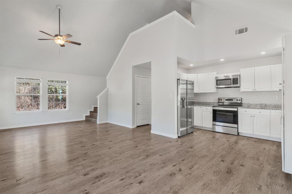 7718 Fm 1886 Azle, TX 76020 - Photo 9 of 16 a view of kitchen with stainless steel appliances granite countertop a stove a sink dishwasher and a refrigerator with wooden floor