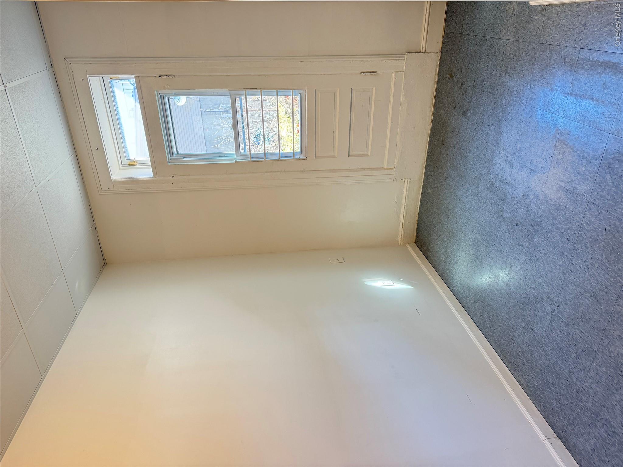 50-05 108th Street Queens, NY 11368 - Photo 5 of 16 an empty room with a empty space and window
