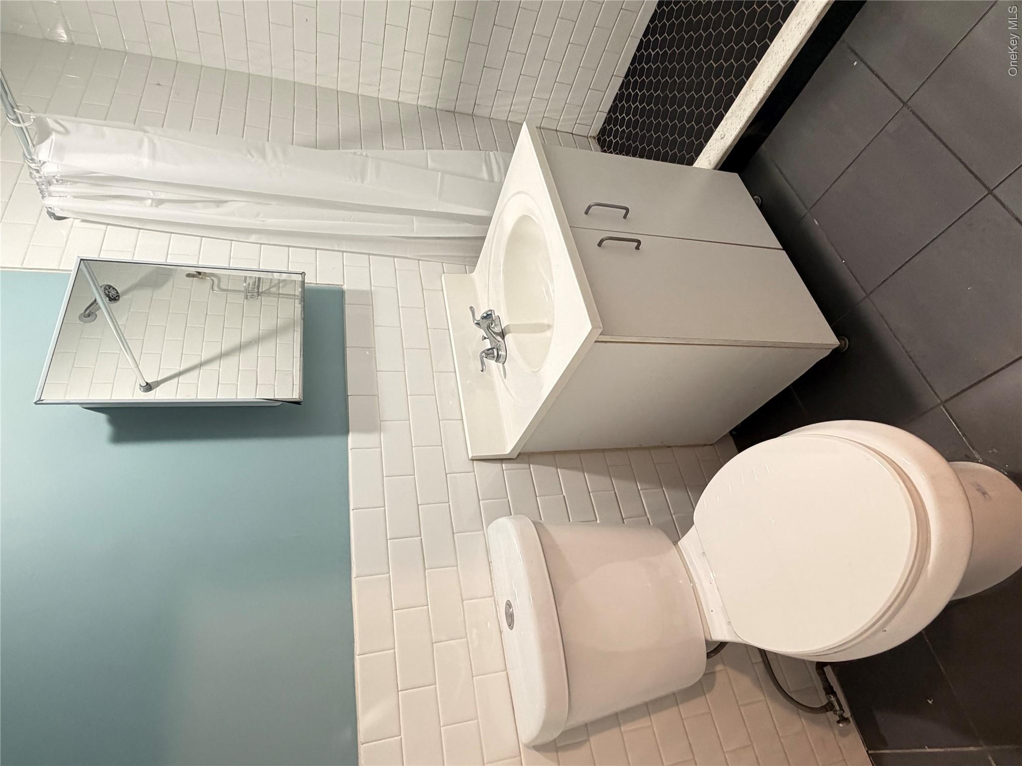 50-05 108th Street Queens, NY 11368 - Photo 6 of 16 a bathroom with a toilet sink and mirror
