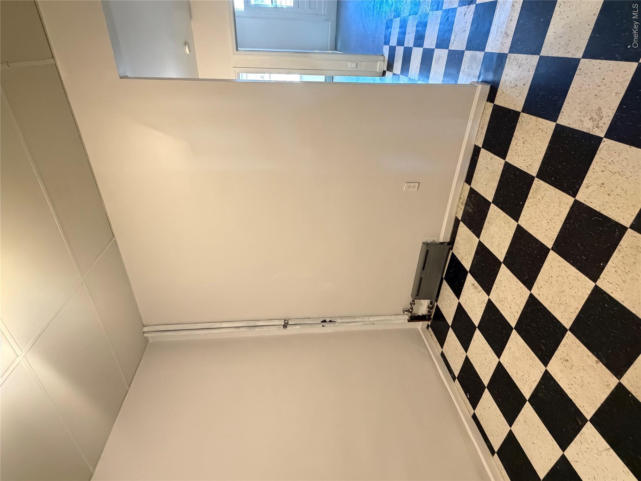 50-05 108th Street Queens, NY 11368 - Photo 7 of 16 a black and white checkered floor with a black white checkered floor