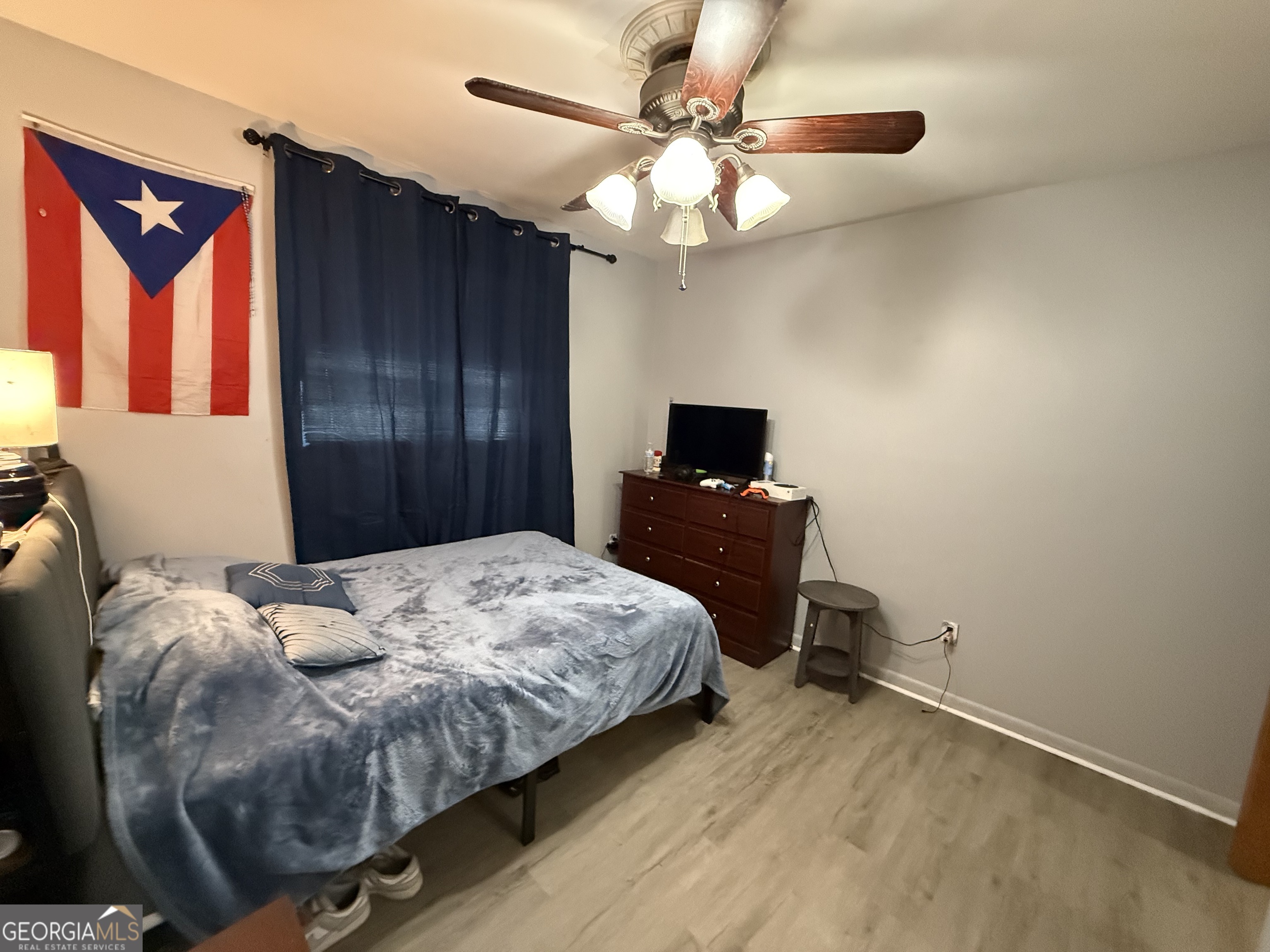 102 Hemlock Street Warner Robins, GA 31093 - Photo 15 of 32 a bedroom with a bed and a chandelier