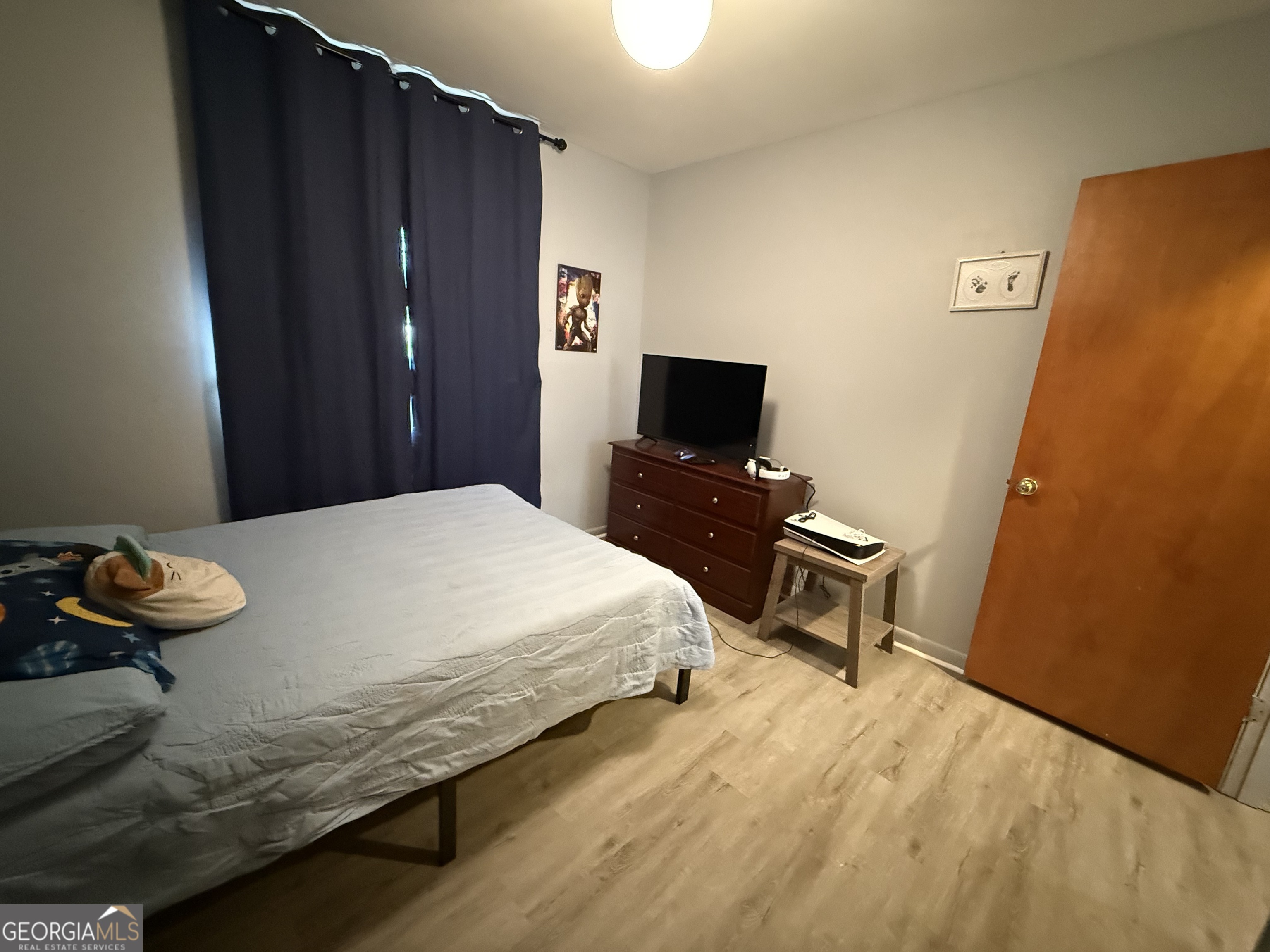 102 Hemlock Street Warner Robins, GA 31093 - Photo 19 of 32 a bedroom with a bed and a tv