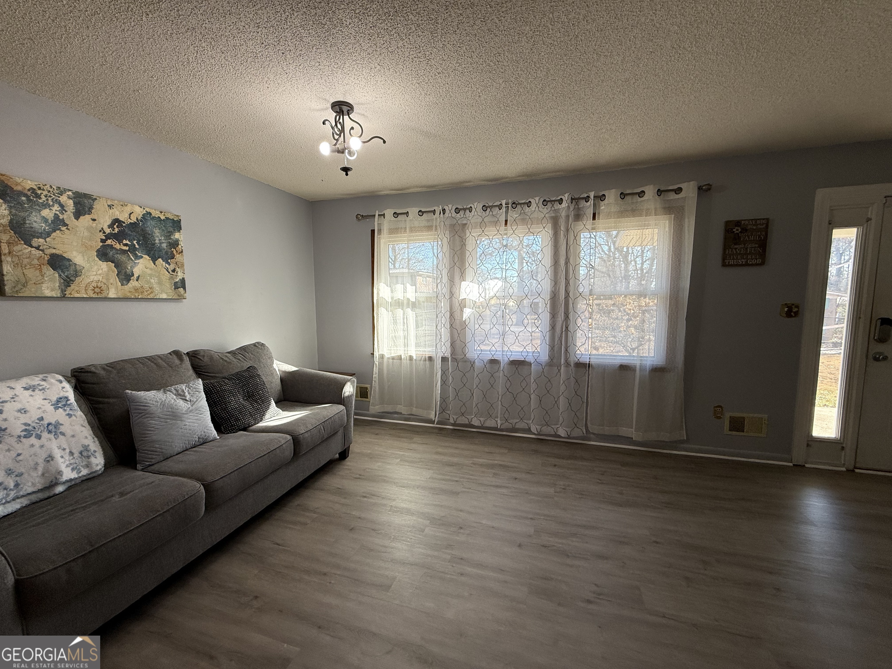 102 Hemlock Street Warner Robins, GA 31093 - Photo 6 of 32 a living room with furniture and a chandelier