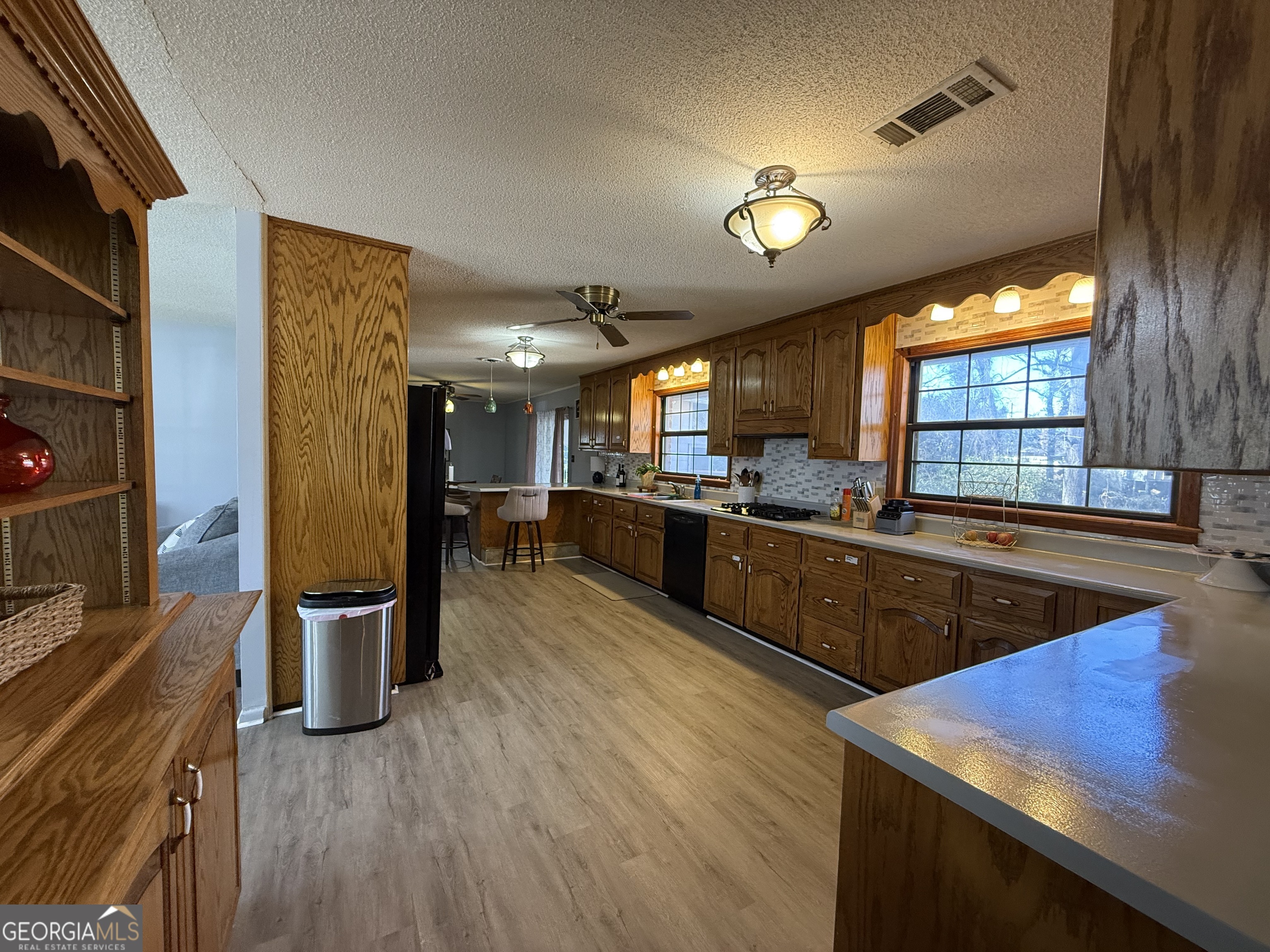 102 Hemlock Street Warner Robins, GA 31093 - Photo 7 of 32 a kitchen with stainless steel appliances granite countertop wooden cabinets a stove and a sink