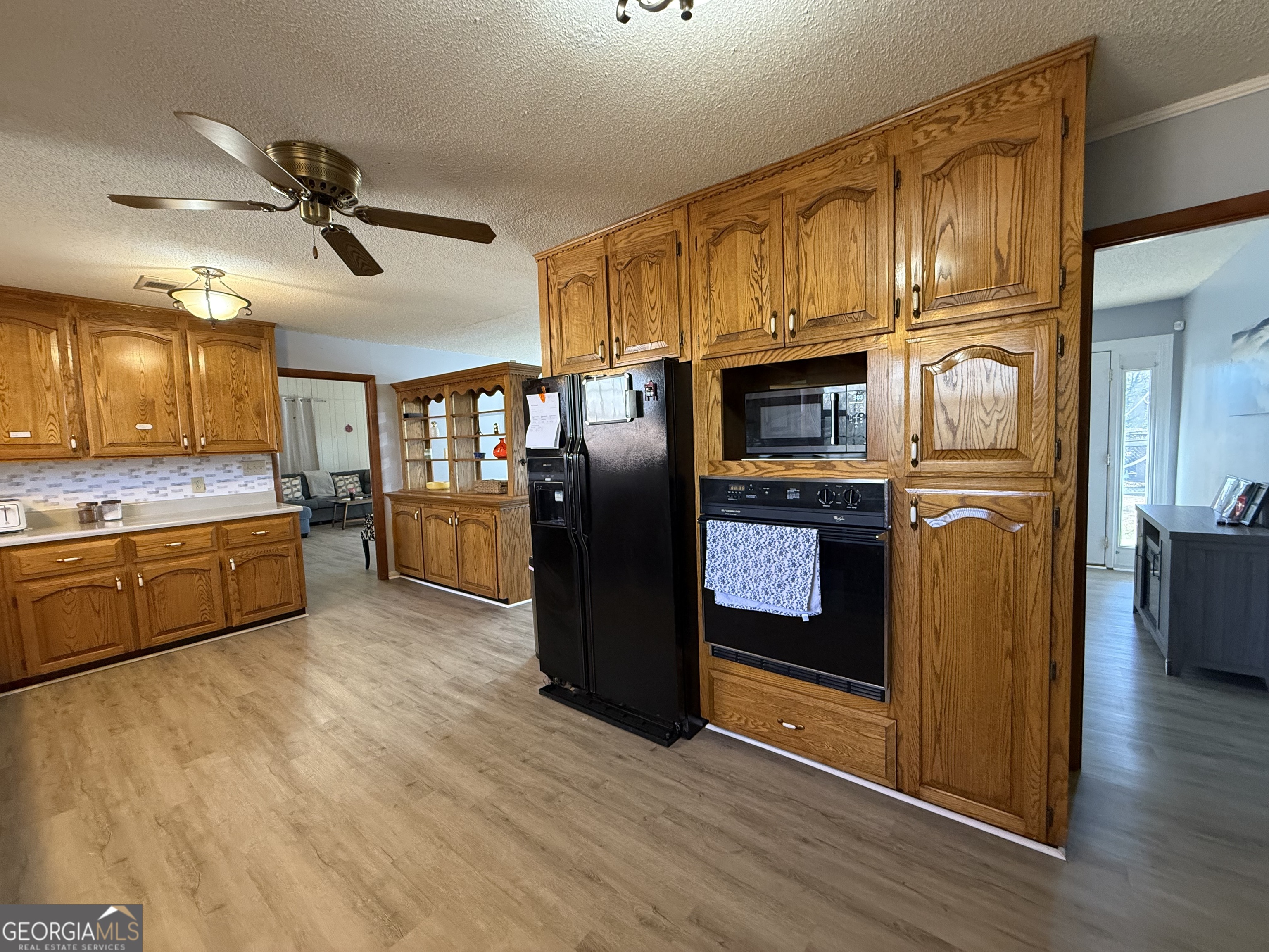 102 Hemlock Street Warner Robins, GA 31093 - Photo 10 of 32 a kitchen with stainless steel appliances granite countertop a refrigerator a oven a sink with wooden cabinets and wooden floor