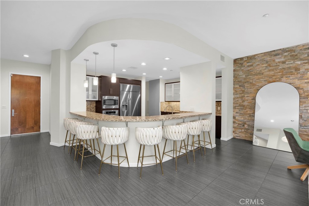 21 Gramercy, Unit 220 Irvine, CA 92612 - Photo 1 of 43 a living room with furniture and a wooden floor