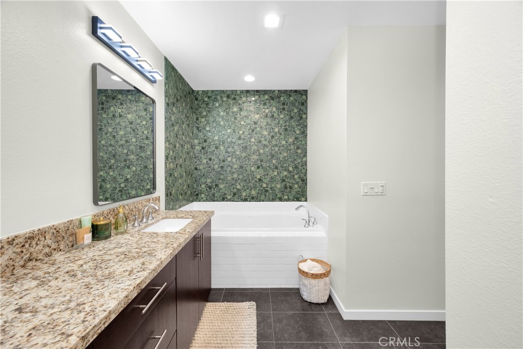 21 Gramercy, Unit 220 Irvine, CA 92612 - Photo 14 of 43 a bathroom with a granite countertop sink a toilet and bathtub