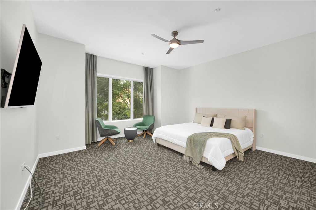 21 Gramercy, Unit 220 Irvine, CA 92612 - Photo 15 of 43 a spacious bedroom with a bed and flat screen tv