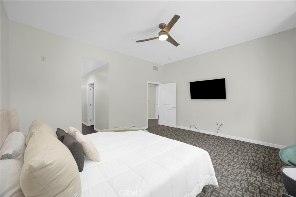 21 Gramercy, Unit 220 Irvine, CA 92612 - Photo 16 of 43 a bedroom with a bed and a flat screen tv