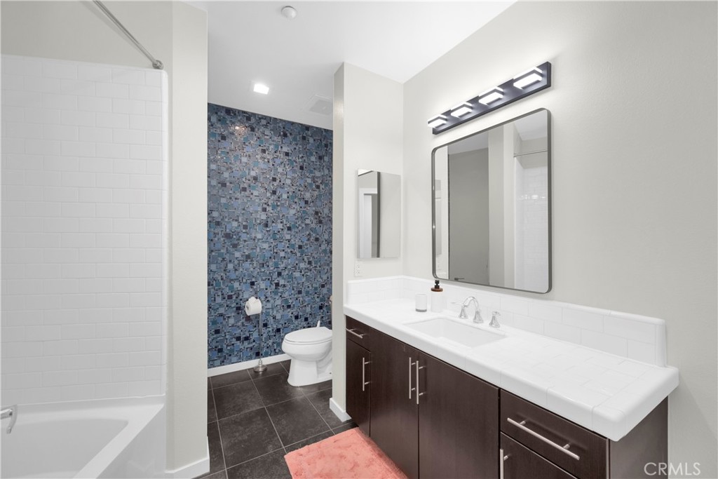 21 Gramercy, Unit 220 Irvine, CA 92612 - Photo 19 of 43 a bathroom with a sink a toilet and a bathtub