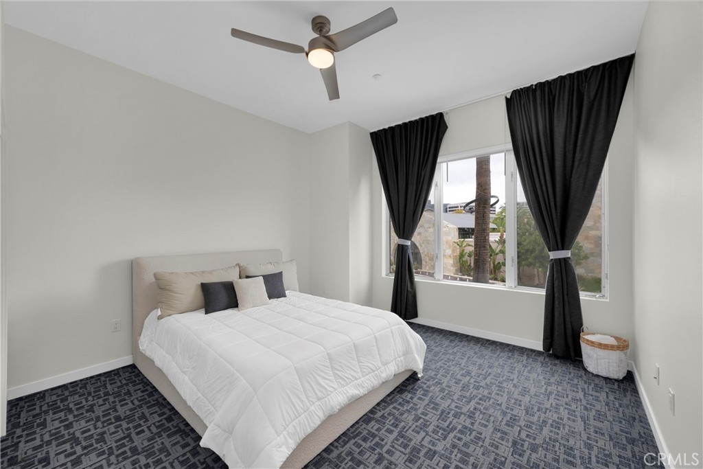 21 Gramercy, Unit 220 Irvine, CA 92612 - Photo 24 of 43 a bedroom with a large bed and a window
