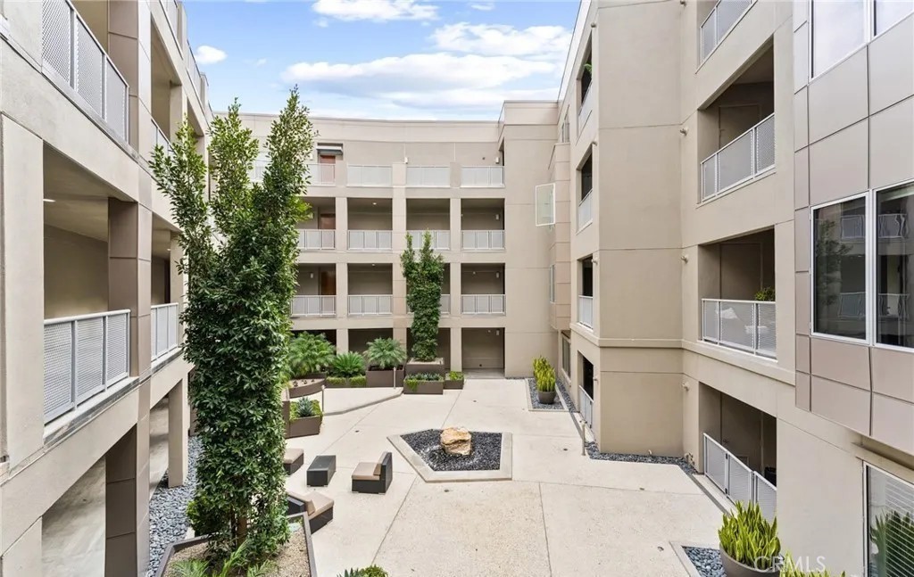 21 Gramercy, Unit 220 Irvine, CA 92612 - Photo 29 of 43 a view of a white building with many windows