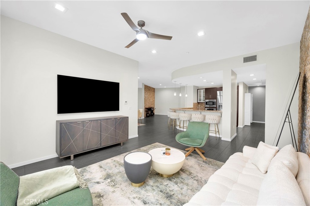 21 Gramercy, Unit 220 Irvine, CA 92612 - Photo 6 of 43 a living room with furniture and a flat screen tv