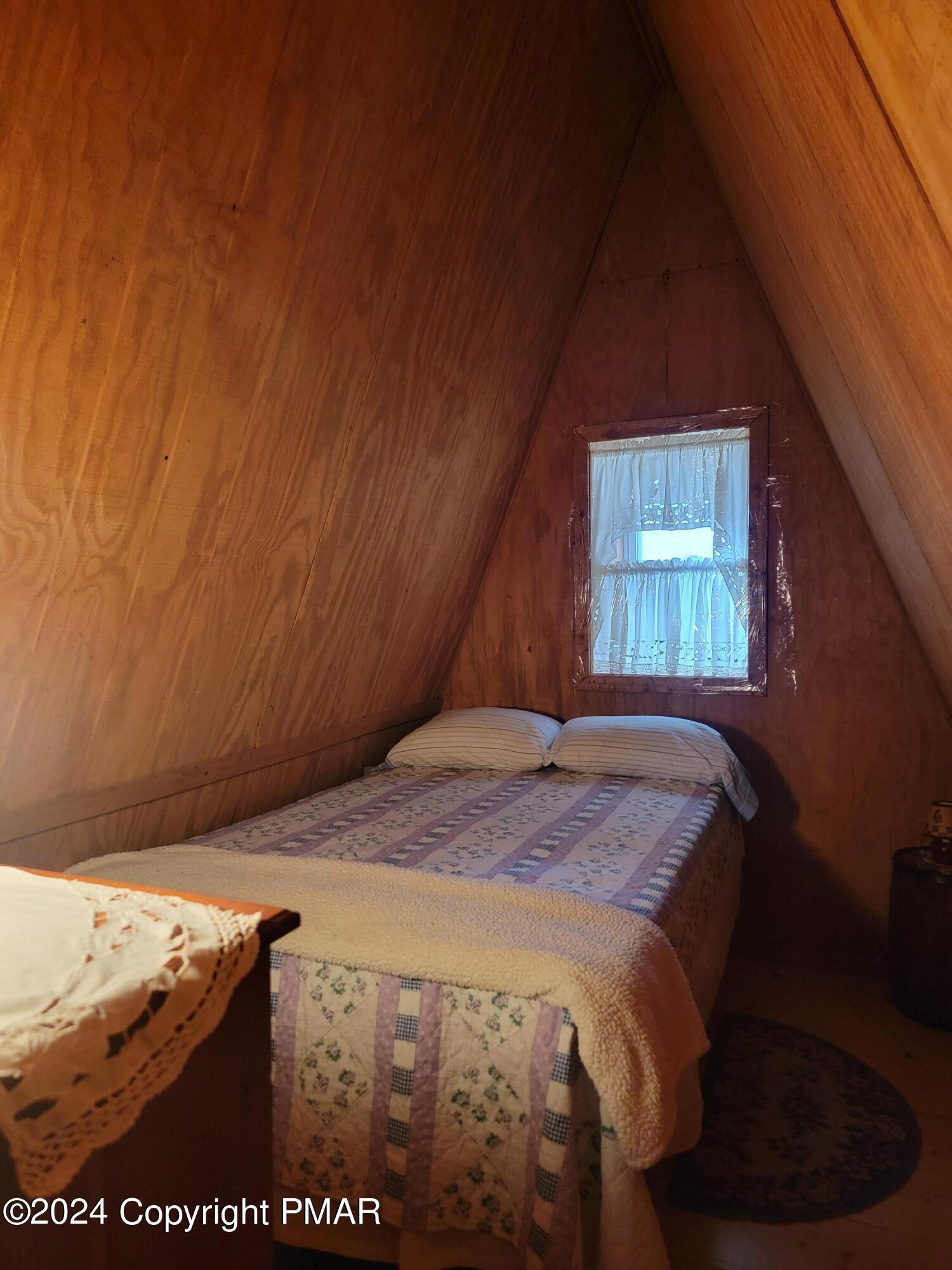 491 Klinger Hill Road Benton, PA 17814 - Photo 23 of 76 a bed sitting in a bedroom next to a window