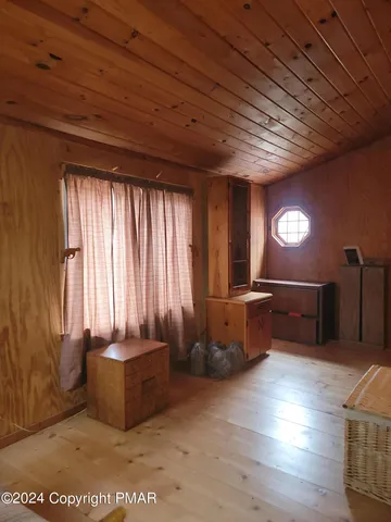 a kitchen with cabinets and wooden floor