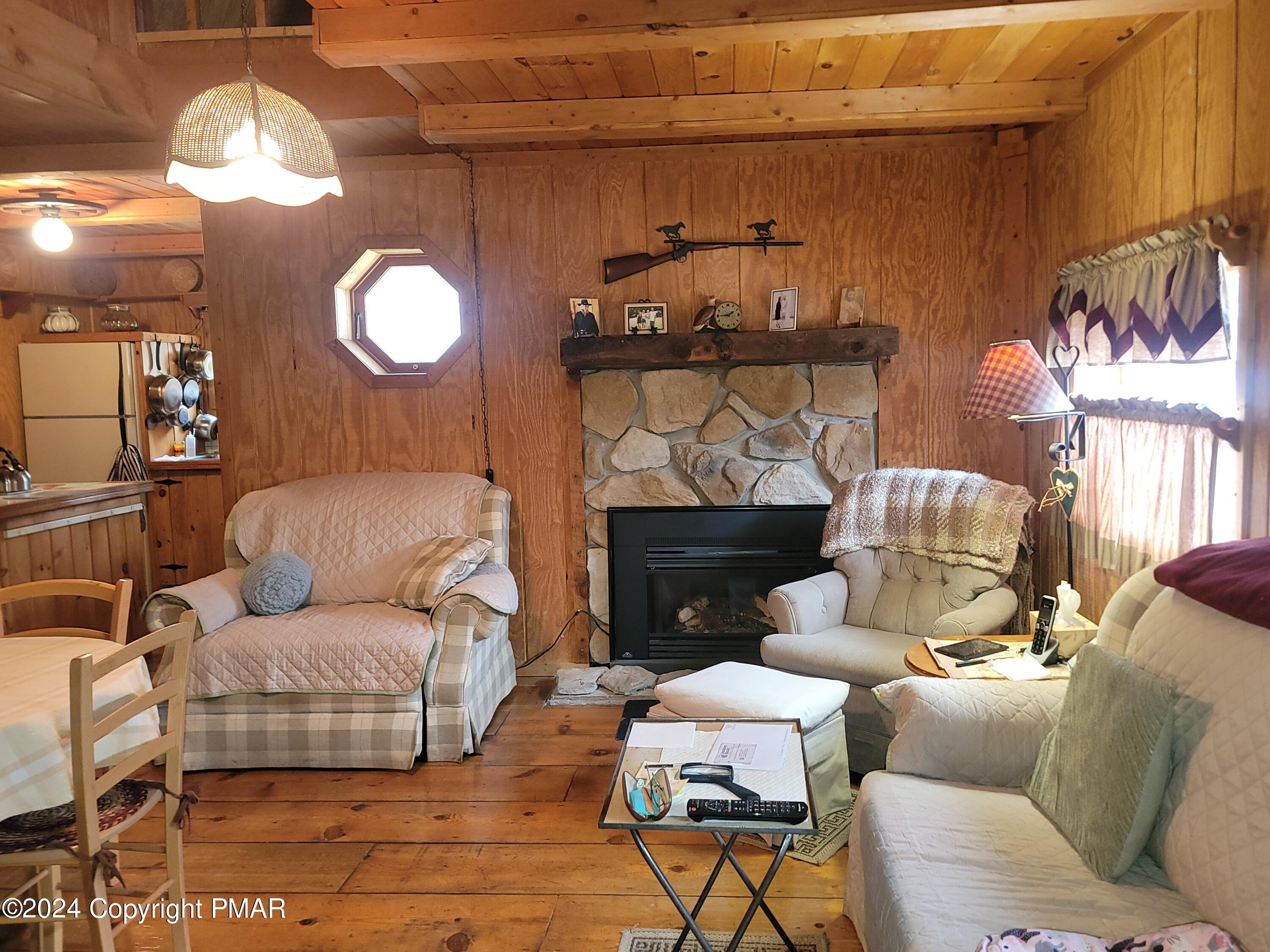 491 Klinger Hill Road Benton, PA 17814 - Photo 40 of 76 a living room with furniture and a fireplace