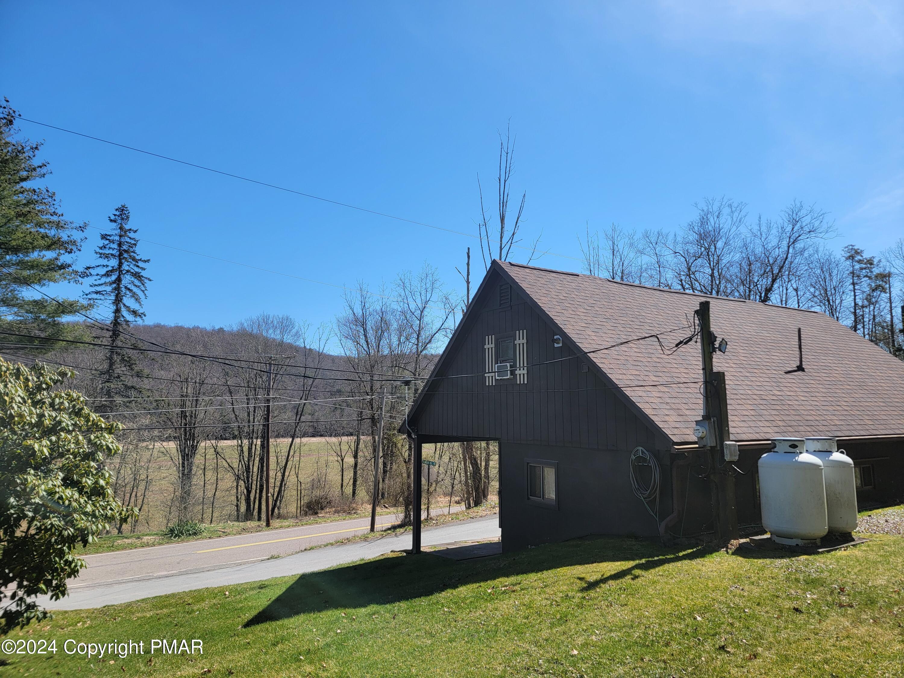 491 Klinger Hill Road Benton, PA 17814 - Photo 6 of 76 a front view of a house with a garden